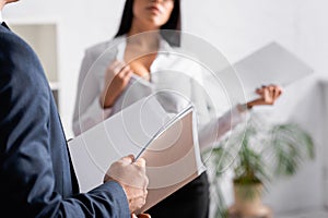 partial view of businessman with paper