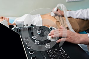 partial view of doctor operating ultrasound