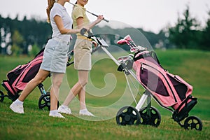 partial view of female golf players in polos walking photo