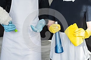 partial view of housekeepers holding cleaning