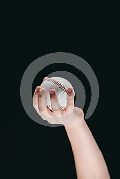 Partial view of kid holding baseball ball