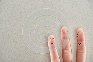 Partial view of man showing three fingers symbolizing aggressive abuser and sad victims on grey background.