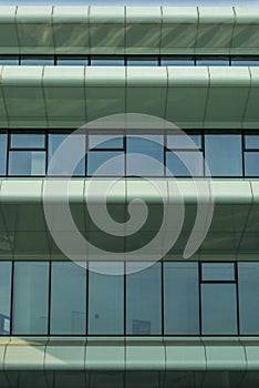 Partial view of a modern, futuristic facade of a research facility with lots of glass and special sun protection