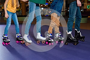 partial view of parents and kids skating on roller