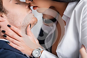 partial view of passionate businesswoman kissing