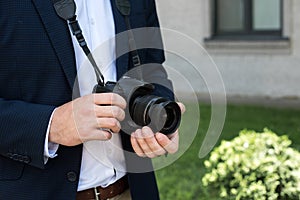 partial view of photojournalist in suit with digital