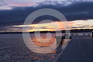 A partial view of a pier on a lake in a winter sunset at Waverly Beach Park, Kirkland, Washington