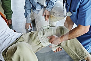 partial view of professional paramedic applying