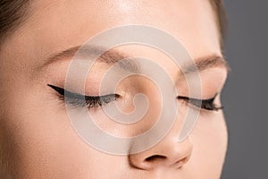 partial view of woman with black eyeliner photo