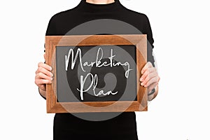 Partial view of woman holding board with lettering marketing plan