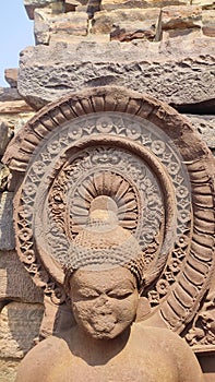 partially damaged Buddha's statue with decorated halo in the sanchi stupa complex originally commissioned by emperor Ashoka