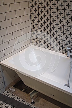 Partially fitted bathtub inside a bathroom.