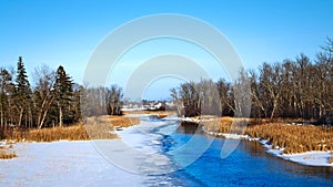 Partially frozen Mississippi River flows north toward Bemidji Minnesota in winter