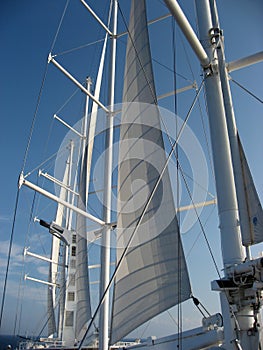 Partially furled sails on large ship