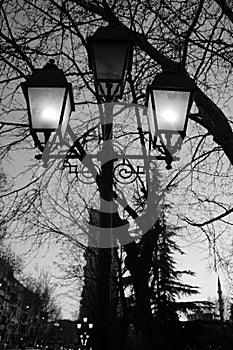 Partially Lit lantern pole street lights along Lana river in Tirana, Albania