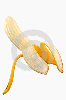 Partially peeled banana resting on a white background
