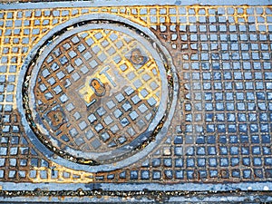 Partially-rusty metal man-hole