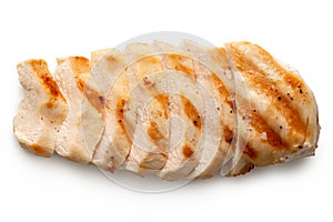 Partially sliced grilled chicken breast with grill marks, ground black pepper and salt isolated on white. Top view