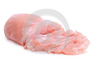 Partially sliced uncooked boned chicken breast isolated on white photo