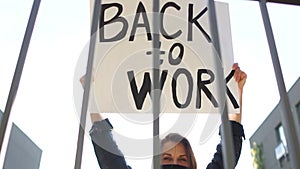 Participant in a demonstration against restriction of rights during the lockdown of coronavirus covid-19. Protest rally