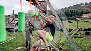 Participant obstacle course doing suspension