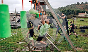 Participant obstacle course doing suspension