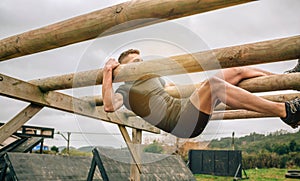 Participant in a obstacle course doing weaver photo