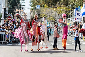 Participants of the annual carnival of Adloyada walking on stilts, dressed in fabulous costumes in Nahariyya, Israel