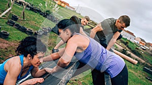 Participants in obstacle course climbing pyramid obstacle