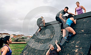 Participants in obstacle course climbing pyramid obstacle