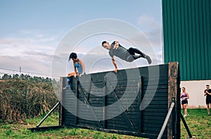 Participants in obstacle course climbing wall