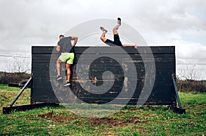 Participants in obstacle course climbing wall