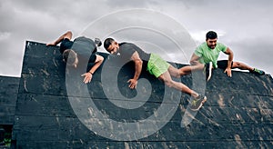 Participants in obstacle course climbing wall
