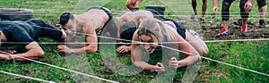 Participants in an obstacle course crawling