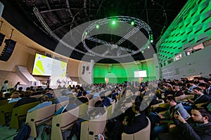 Participants of science conference in spacious hall