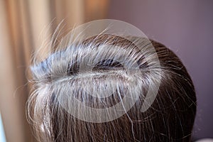 Parting of women's hair on the head. Hair care and care.