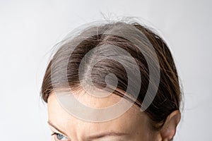 Parting of women& x27;s hair on the head. Hair care and care.