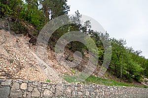 A partition next to the road protects the road from the blockage of stones