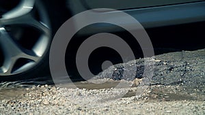 Partly fixed hole in road while car drives over