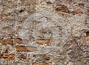 Partly plastered brick wall with rich texture