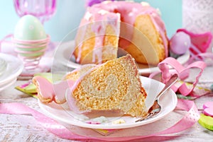 Partly sliced easter ring cake with pink icing