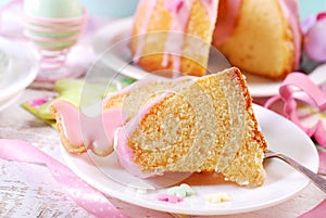 Partly sliced easter ring cake with pink icing