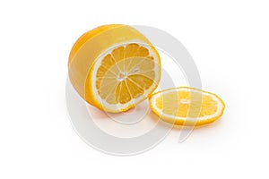 Partly sliced Meyer lemon on a white background