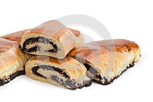 Partly sliced poppy seed pies on a white background