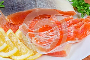 Partly sliced salted arctic char on a dish close-up