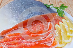 Partly sliced salted arctic char on a dish close-up