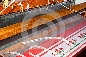 Partly woven carpet, rug on a loom shows wool pile, foundation