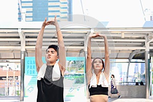 Partner buddy runner man and woman stretching body before exercise run outdoor, two Asian jogger athlete training and doing