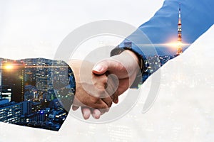 Partner. double exposure business man investor handshake with modern office building night light background