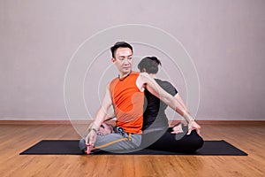 Partner Twist Yoga Pose by a couple